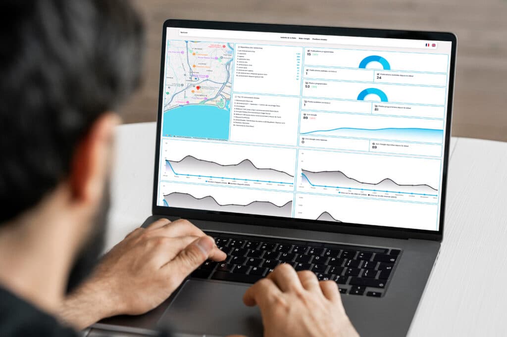 SEO Local Nice : Analyse du tableau de bord de performance Mains tapant sur un ordinateur portable affichant un tableau de bord d'analyse de performance SEO locale et une carte de Nice. Statistiques appels, publications et recherches.